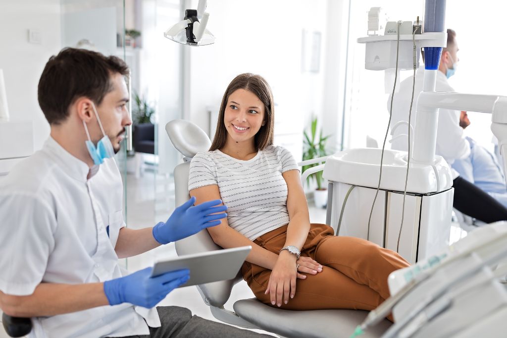 Dentist talking to a dental patient.