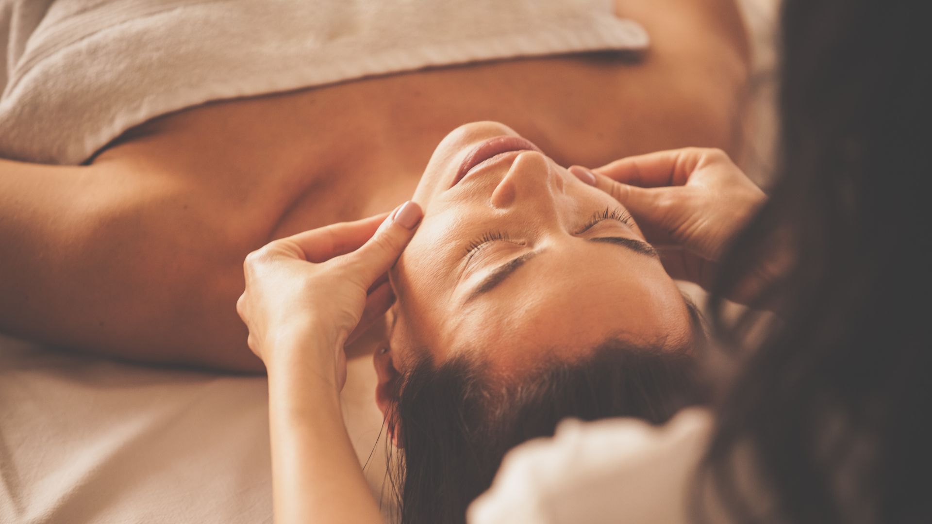 Photo of a woman having a facial cosmetic treatment.